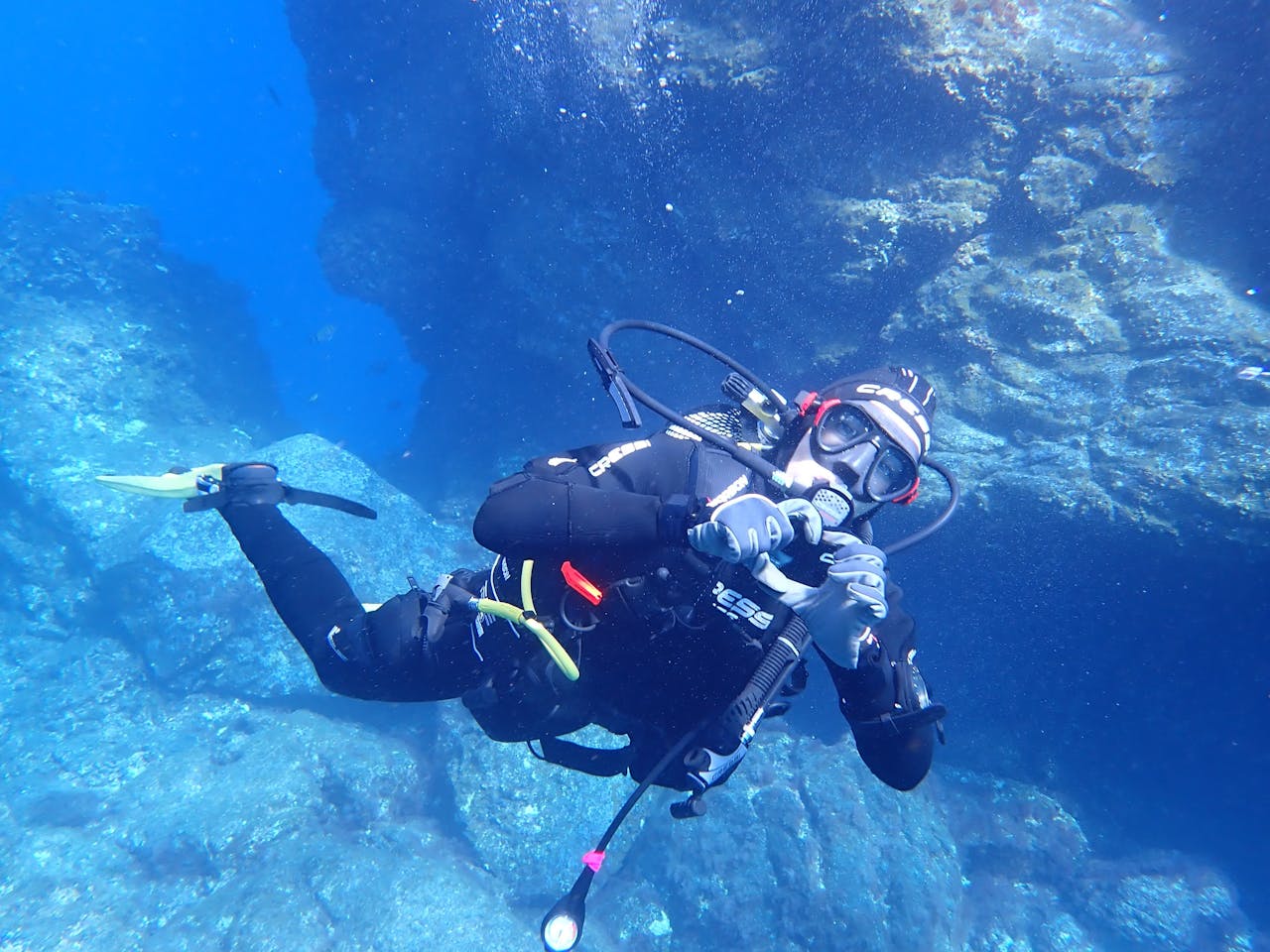 Scuba diver explores underwater landscape in Spanish seas, showcasing marine life and adventure.